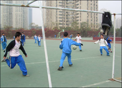 Children Playing Football At School