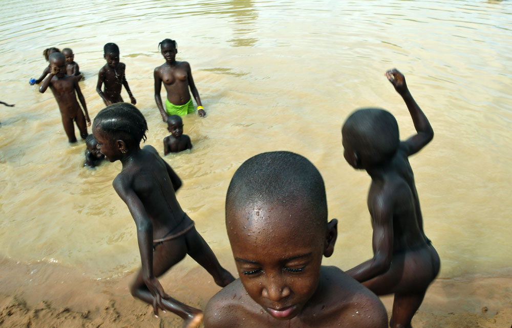 Children Playing In Rainy Season