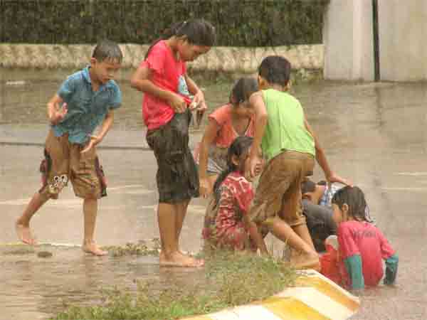 Children Playing Football In Rain