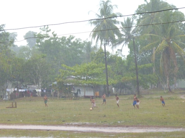 Children Playing Football In Rain