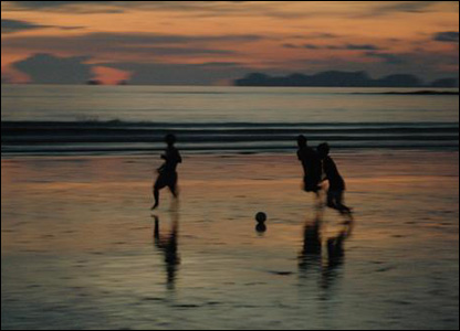 Children Playing Football On The Beach