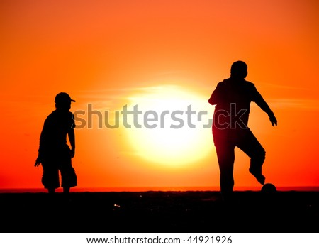 Children Playing Football On The Beach